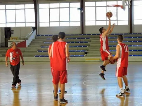 a group of people playing basketball