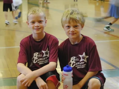 two boys sitting on the floor