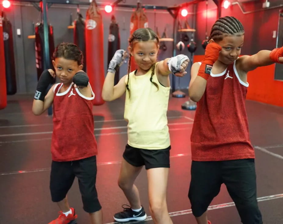 a group of kids in a boxing ring