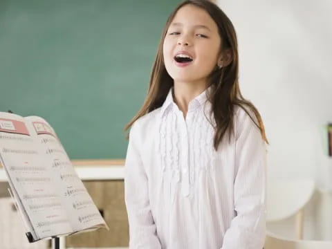 a girl holding a piece of paper