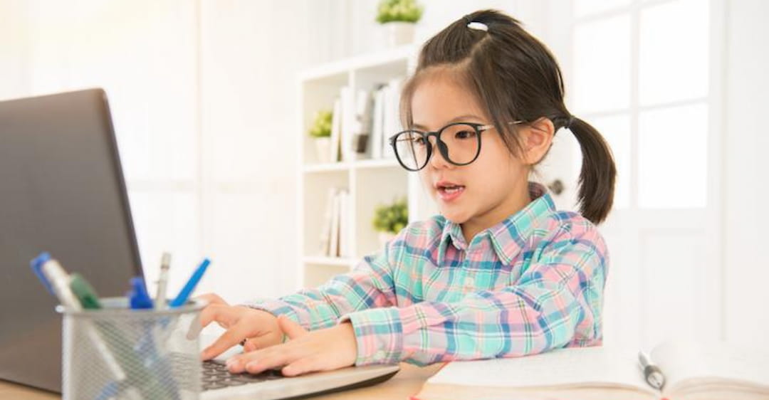 a young girl using a laptop
