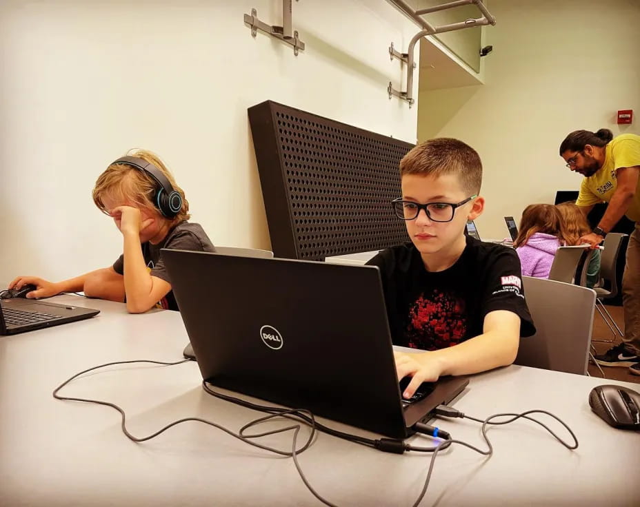 a group of people using laptops