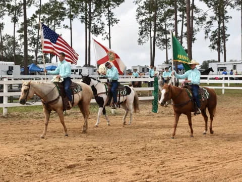 a group of people riding horses