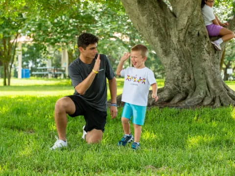 a person and a child playing in a park