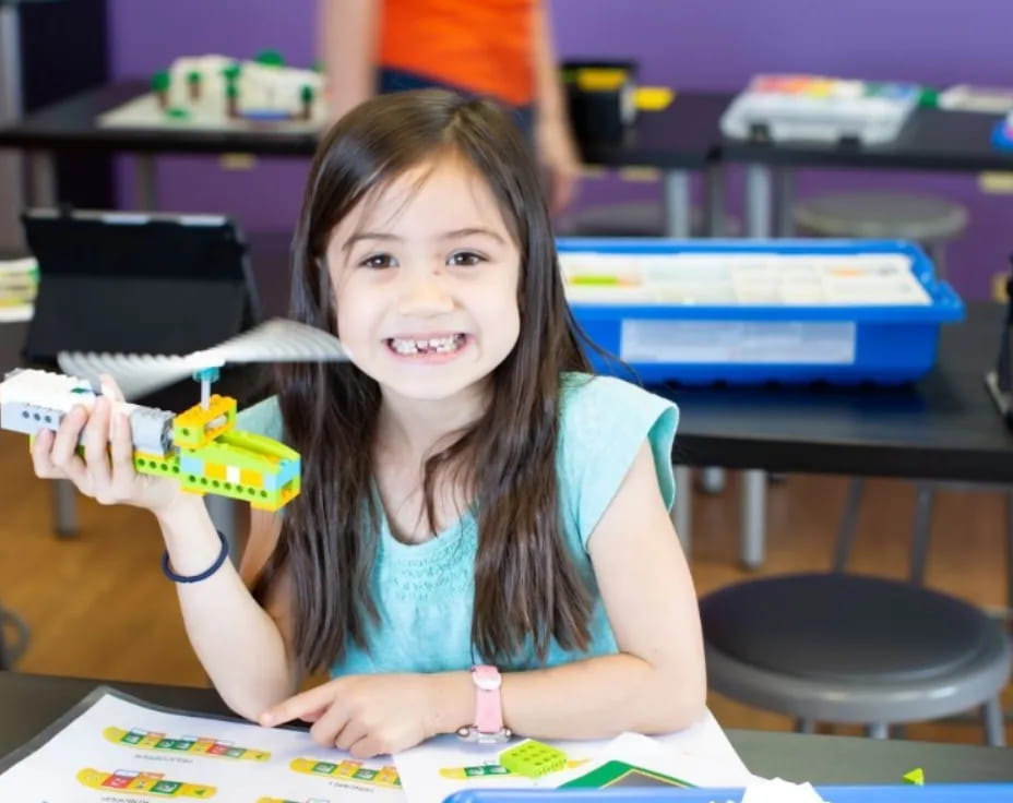 a girl holding a toy