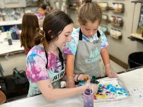 a person and a child painting