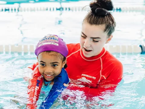 a person and a child in a pool