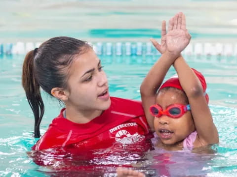 a person and a baby in a pool