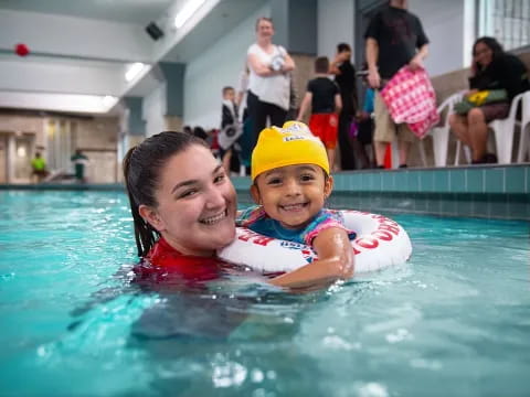 a person and a child in a pool