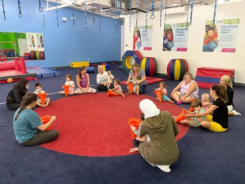 a group of children sitting on the floor in a classroom