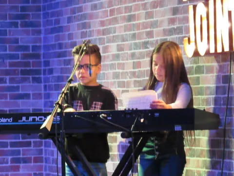 a man and woman playing piano