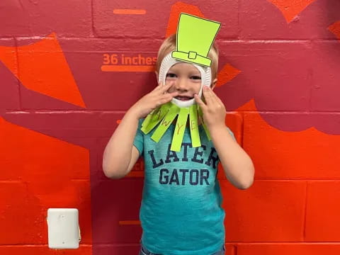 a boy wearing a birthday hat