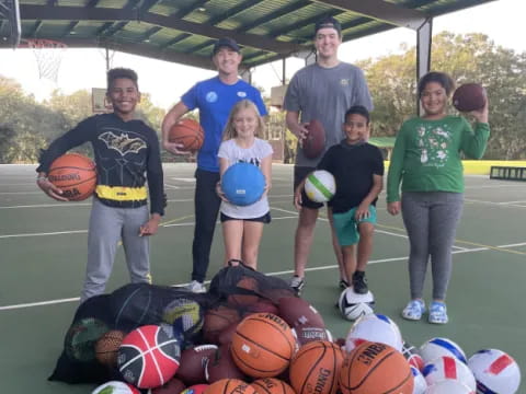 a group of people holding balls