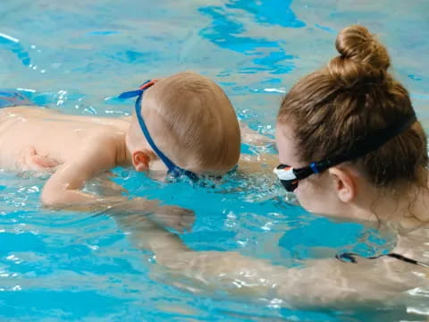 a person and a child in a pool