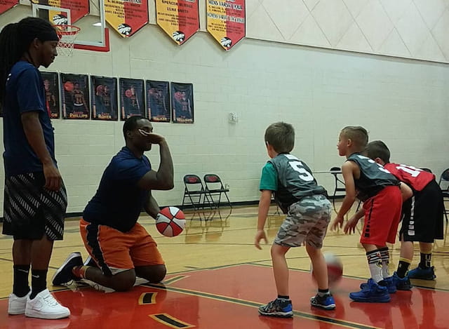 a group of kids playing basketball