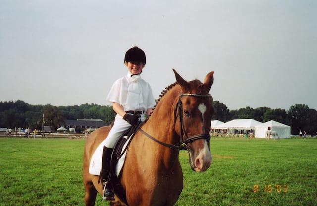a boy riding a horse