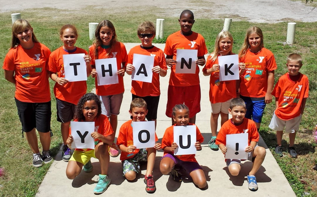 a group of people wearing orange shirts