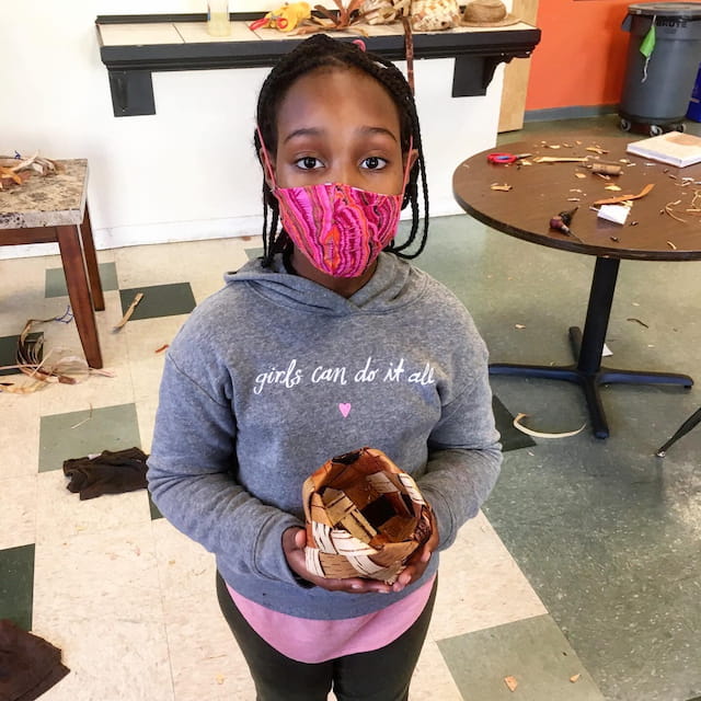 a girl holding a cookie