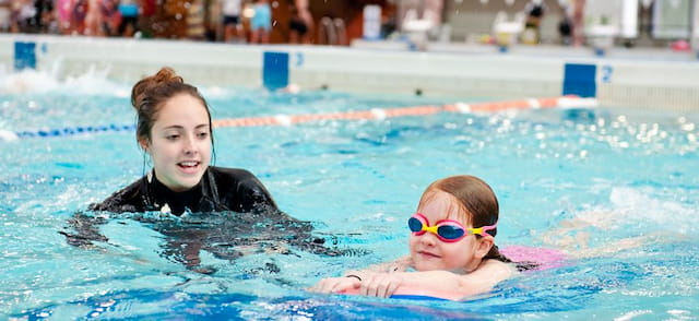 a person and a child in a pool