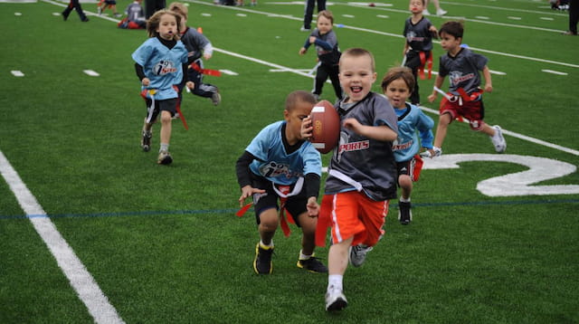 a group of kids playing football