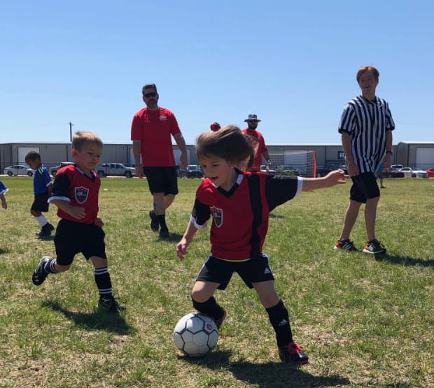 a group of kids playing football