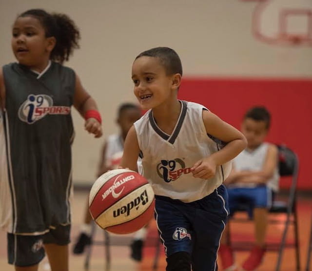 a couple of kids playing basketball