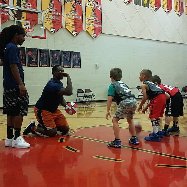 a group of kids playing basketball