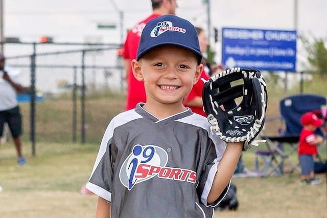 a boy holding a baseball glove