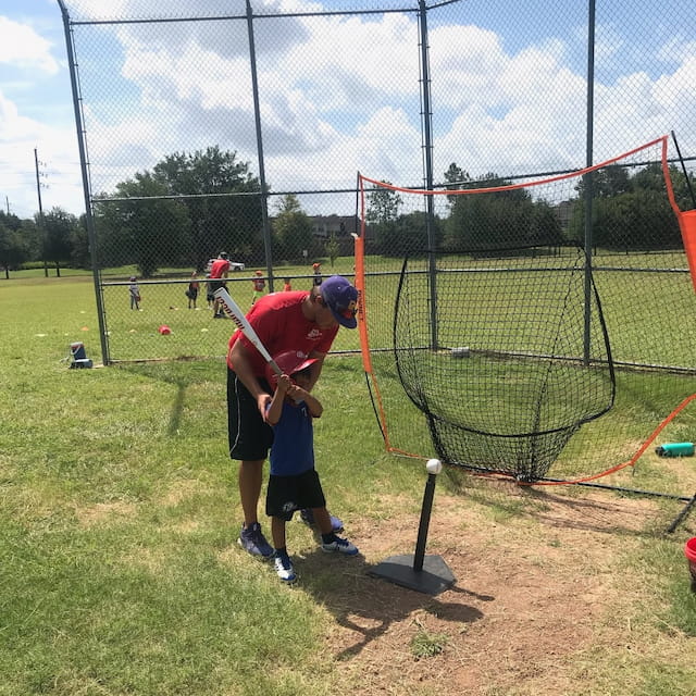 a person swinging a baseball bat