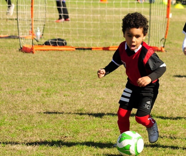 a young boy playing football