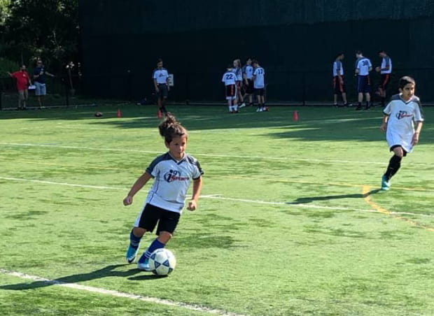 kids playing football on a field