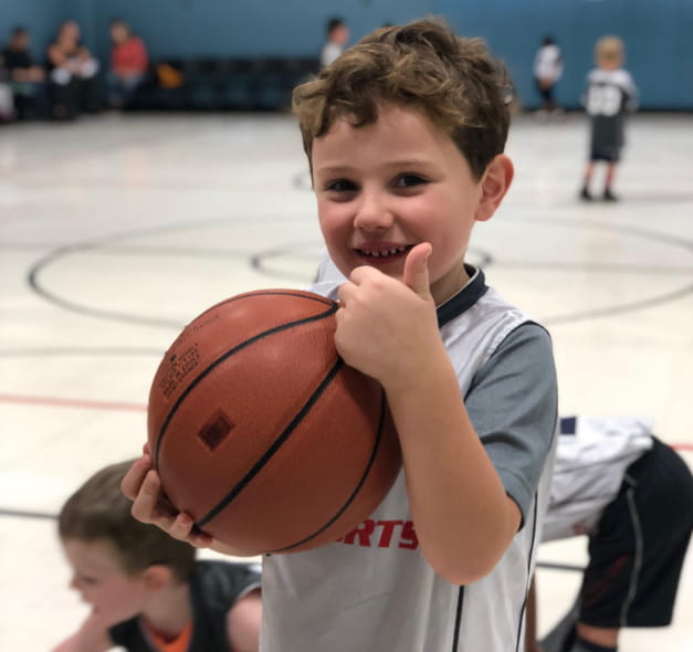 a boy holding a basketball