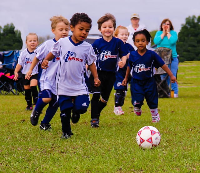 a group of kids playing football