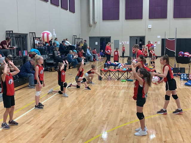 a group of people playing volleyball