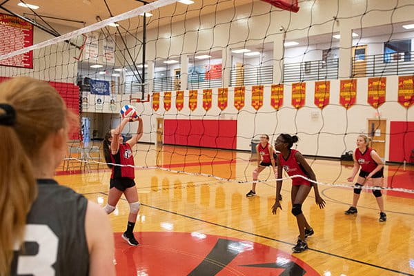 a group of women playing volleyball