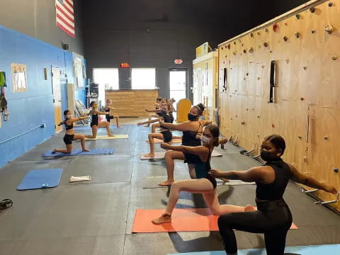 a group of people exercising in a gym