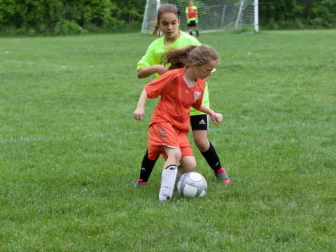 girls playing football on a field