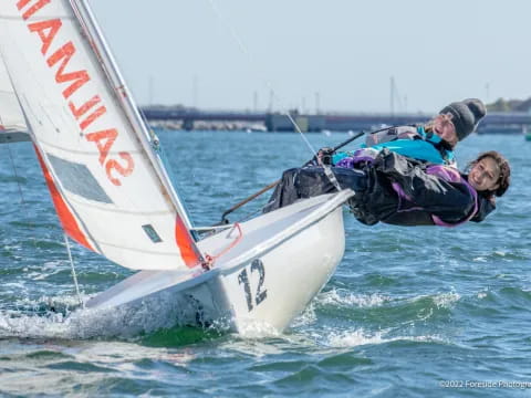 a man and a woman on a sailboat