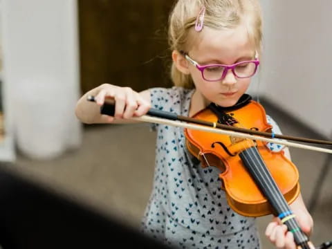 a girl playing a violin