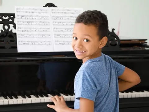 a boy playing a piano