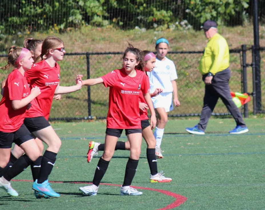a group of girls running on a field