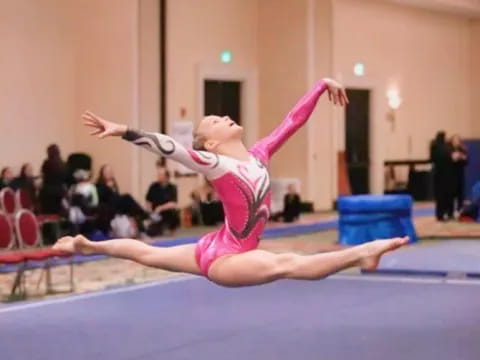 a woman doing a gymnastics move