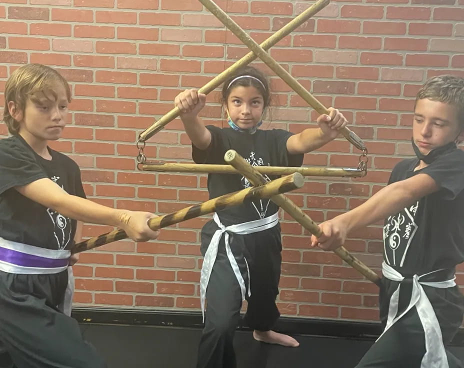 a group of boys holding swords