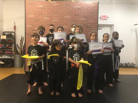 a group of children holding certificates