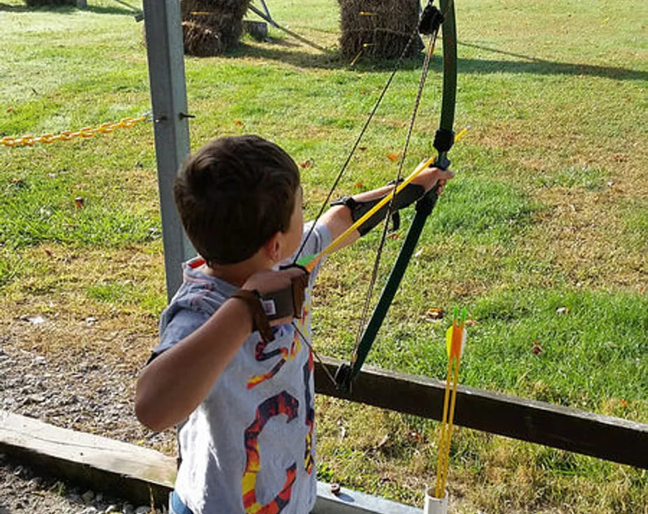 a boy shooting a bow