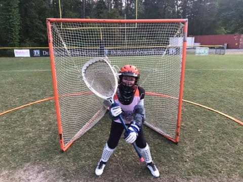 a girl playing lacrosse