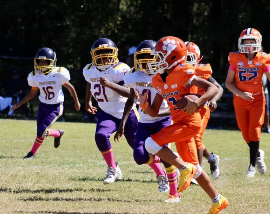 a group of kids playing football