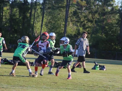 a group of kids playing lacrosse