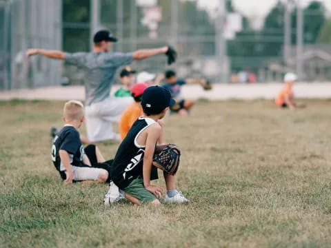 a group of kids playing baseball