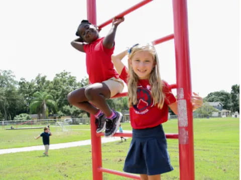 a girl jumping on a pole
